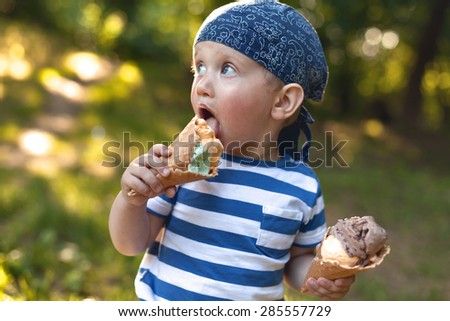 Boy eating ice-cream and playing with his mom