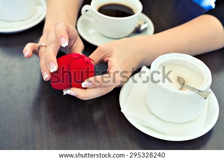 engagement ring and coffee on the table