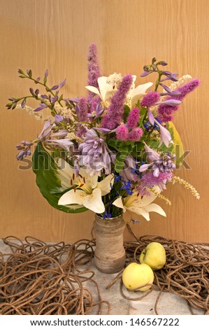 still life bouquet of hemerocallis and astilbe with rope and apples