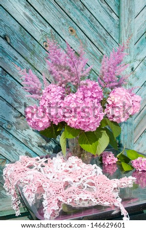 Still life bouquet with pink hydrangea and astilbe with homemade crochet tablecloth
