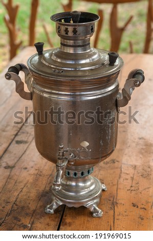samovar - traditional Russian utensil, on the wooden table
