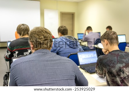 people sitting rear at the computer training class