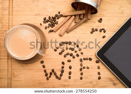 office worker\'s coffee break: composition of tablet, wi-fi world composed of coffee beans, cup of coffee with milk