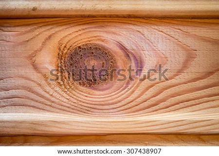 A wood knot in a wooden beam. Looks like a wooden eye.