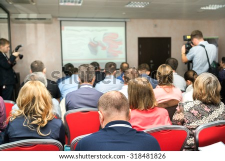 Business Conference and Presentation. The audience listens to the acting in a conference hall