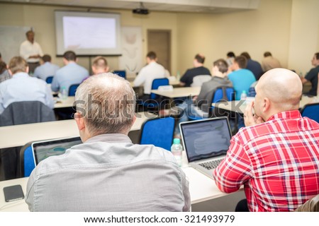 people sitting rear at the business training in a computer classroom