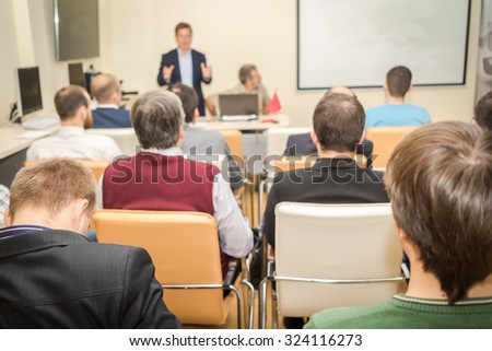 The audience listens to the acting in a conference hall.