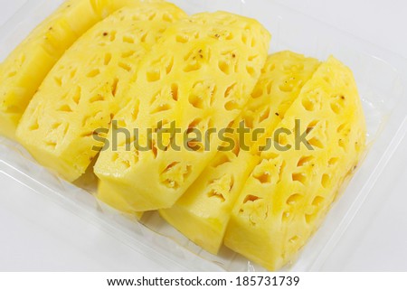 A composition of pineapple chunks freshly cut.