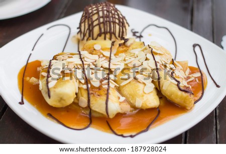 Banana crepe caramel with ice-cream on white plate