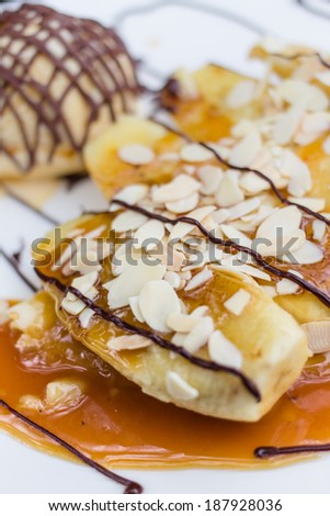 Banana crepe caramel with ice-cream on white plate