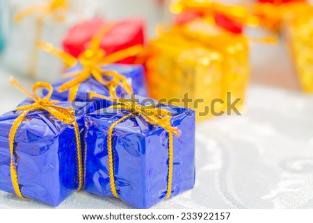 Colorful and striped boxes with gifts tied bow