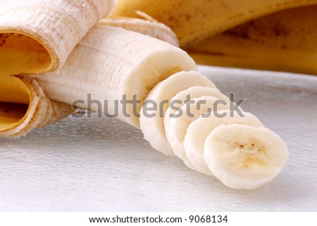 Sliced banana on a glass cutting board