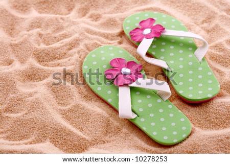 flip flops in the sand. pink flip flops in sand