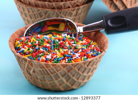 waffle cone bowl full of sprinkles with ice cream scoop