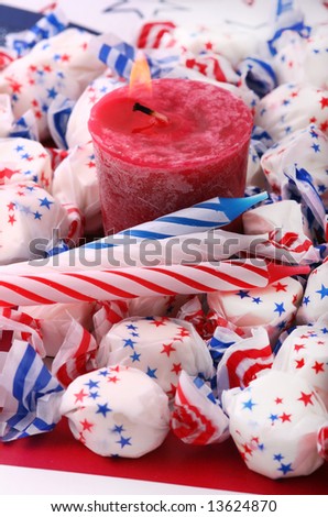 lit votive candle with b-day candles and salt water taffy