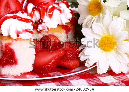 slices of jelly filled angel food cake with strawberries and flowers