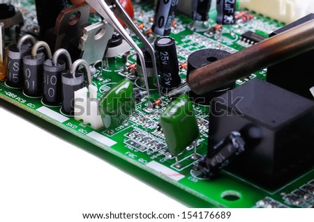 Electronic technician operates with circuit board. Close-up. Isolated on white  background.
