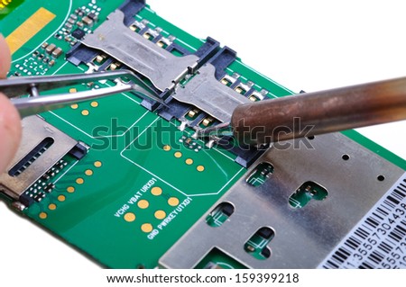 Electronic technician operates with SIM slot on mobile phone circuit board. Close-up with selective focus and Shallow Depth of Field. Isolated on white background.