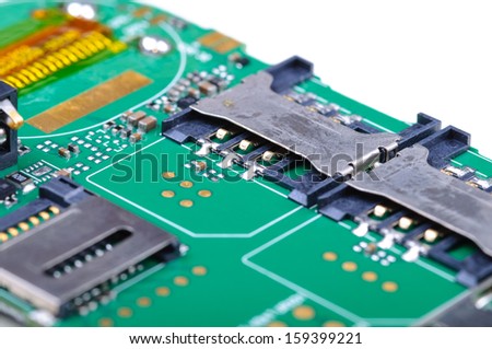 Part of the mobile phone circuit board with two SIM slots and memory card holder. Close-up with selective focus and Shallow Depth of Field. Isolated on white background.