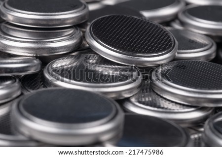 Heap of lithium button cell batteries. Closeup with shallow DOF.