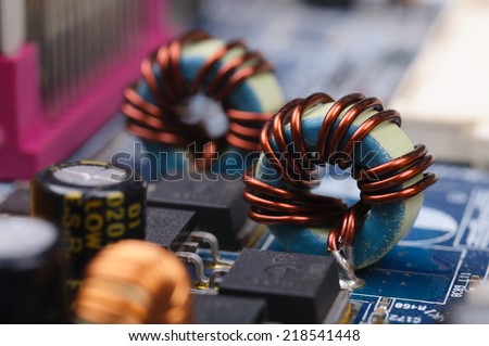 Part of PC main board with electronic components. Closeup with shallow DOF.