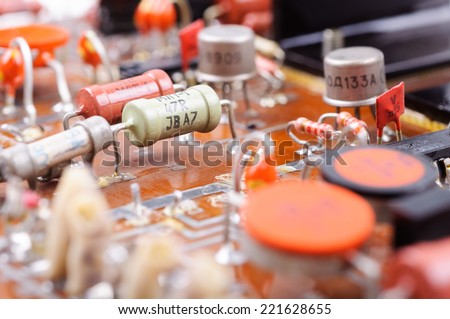 Part of old vintage printed circuit board with electronic components. Closeup with shallow DOF.