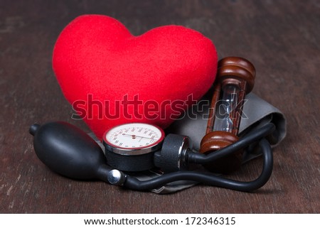 Medical, Group of objects on wood table.  measure blood pressure, red heart ,hourglass