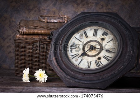 Group of objects on wood table. antique wooden clock , flower, wood basket, Still life