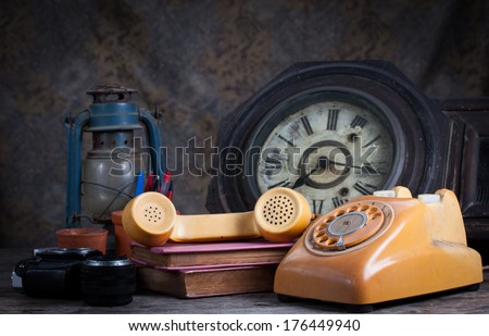 Group of objects on wood table. old telephone, type writer, old camera, Still life