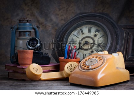 Group of objects on wood table. old telephone, type writer, old camera, Still life