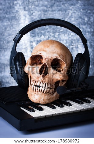 Human skull with earphones, still life