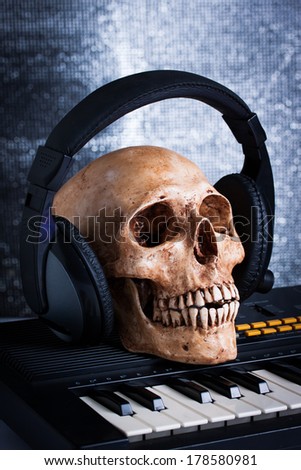 Human skull with earphones, still life