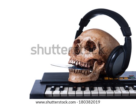 Human skull with earphones, put dvd in mouth