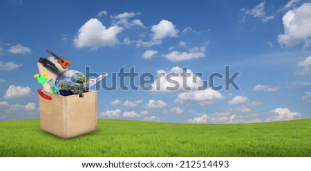 Wooden toys box on hill and blue sky with clouds in the background.(Elements of this image furnished by NASA)