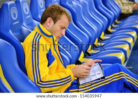 KIEV, UKRAINE - SEP 10: Gusev looks program for the qualifying match 2014 World Cup between Ukraine vs England, 10 September 2013, NSC Olympic Stadium, Kiev, Ukraine