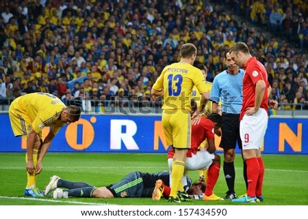 KIEV, UKRAINE - SEP 10: Pyatov assist as a result of an injury on the football field during the qualifying match 2014 World Cup, 10 September 2013, NSC Olympic Stadium, Kiev, Ukraine