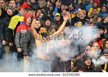 KIEV, UKRAINE - NOV 15: Ultras burn fireworks in the stadium during the play-off match for the 2014 World Cup between Ukraine vs France, 15 November 2013, NSC Olympic Stadium, Kiev, Ukraine