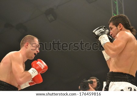 CHERKASSY, UKRAINE - DEC 15: Sergei Fedchenko (L) boxed against Azad Azizov (R) in the fight for the European title by the WBO junior welterweight, 15 December 2012, Budyvelnik, Cherkasy, Ukraine