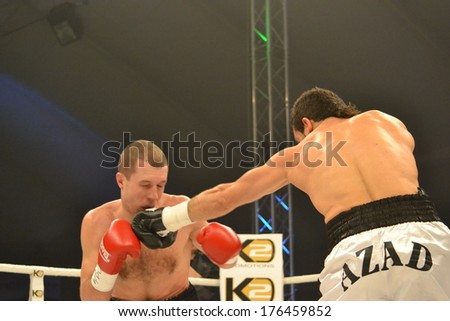 CHERKASSY, UKRAINE - DEC 15: Sergei Fedchenko (L) boxed against Azad Azizov (R) in the fight for the European title by the WBO junior welterweight, 15 December 2012, Budyvelnik, Cherkasy, Ukraine