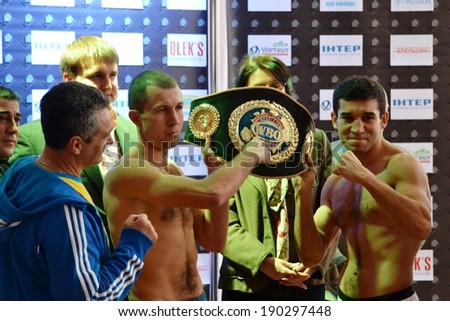 CHERKASSY, UKRAINE - DEC 15: Sergei Fedchenko (L) and Azad Azizov (R) at the pre-fight weigh-in with championship belt for European title by the WBO, 15 December 2012, Cherkasy, Ukraine