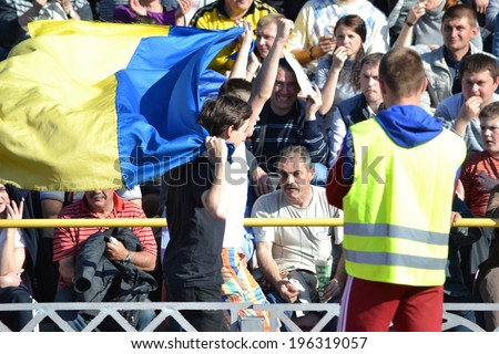 CHERKASSY, UKRAINE - MAY 7: Man runs with a Ukrainian flag during the semifinal match of the Cup of Ukraine on football between FC Slavutich - FC Shakhtar Donetsk, 7 May 2014, Cherkassy, Ukraine