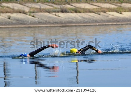 CHERKASSY, UKRAINE - AUG 8: Swimmers rowing during in VI International swim across the Dnieper River, 10 km, 8 August 2014, Cherkassy, Ukraine