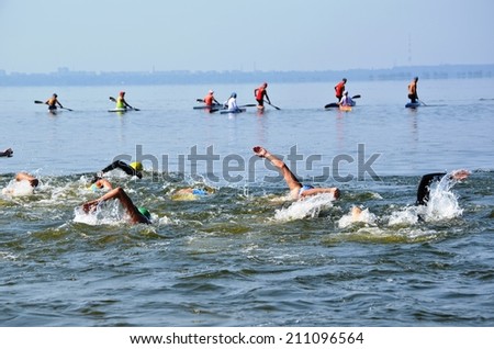 CHERKASSY, UKRAINE - AUG 8: Swimmers rowing during VI International swim across the Dnieper River, 10 km, 8 August 2014, Cherkassy, Ukraine