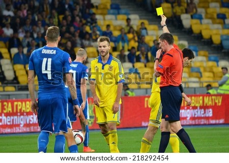 KIEV, UKRAINE - SEP 8: Football player gets a yellow card from the referee during the match Ukraine 0-1 Slovakia UEFA Euro 2016 qualifier match, 8 September 2014, Kiev, Ukraine