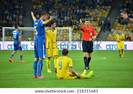 KIEV, UKRAINE - SEP 8: Footballer broke the rules and throws up his hands during the match Ukraine 0-1 Slovakia UEFA Euro 2016 qualifier match, 8 September 2014, Kiev, Ukraine