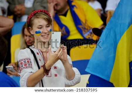 KIEV, UKRAINE - SEP 8: Fans of Ukraine and the girls in the stands during the match Ukraine 0-1 Slovakia UEFA Euro 2016 qualifier match, 8 September 2014, Kiev, Ukraine