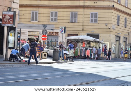 ROME - AUGUST 27, 2014: Tourists walking along the ancient streets of Rome, Rome, Italy