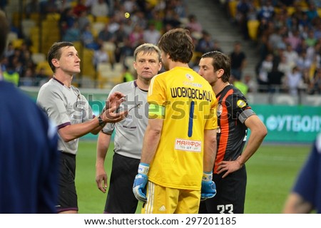 KIEV, UKRAINE - JUN 4: The referee tosses a coin during the final match Cup of Ukraine between Shakhtar vs Dynamo Kiev, 4 June 2015, NSC Olympic Stadium, Kiev, Ukraine