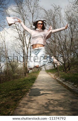 Woman jumping and having fun in the park