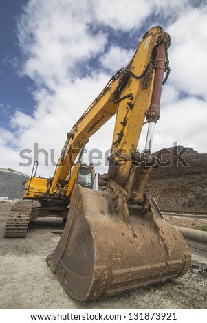A yellow bulldozer parked in a construction